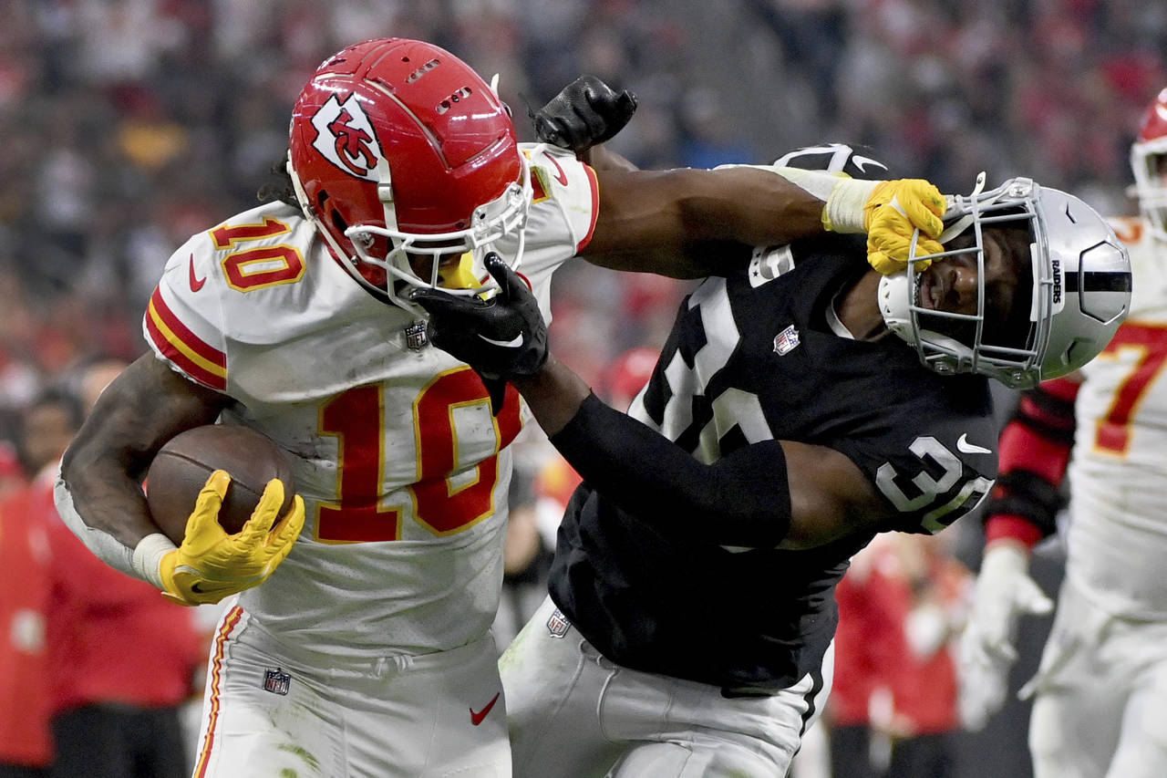 Kansas City Chiefs running back Isiah Pacheco (10) struggles for yardage as Las Vegas Raiders safet...