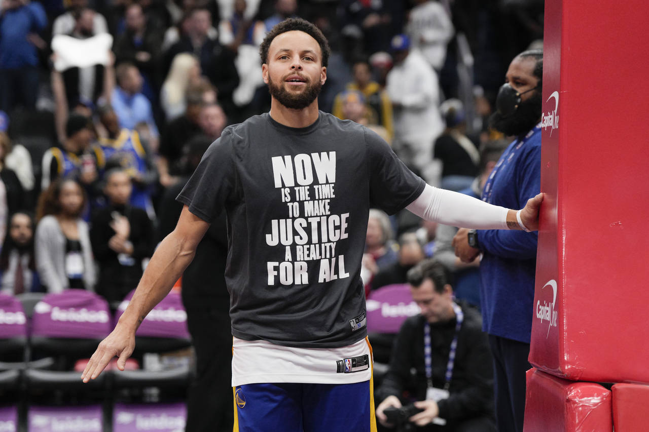 Golden State Warriors guard Stephen Curry (30) warms up in a shirt honoring Martin Luther King Jr. ...