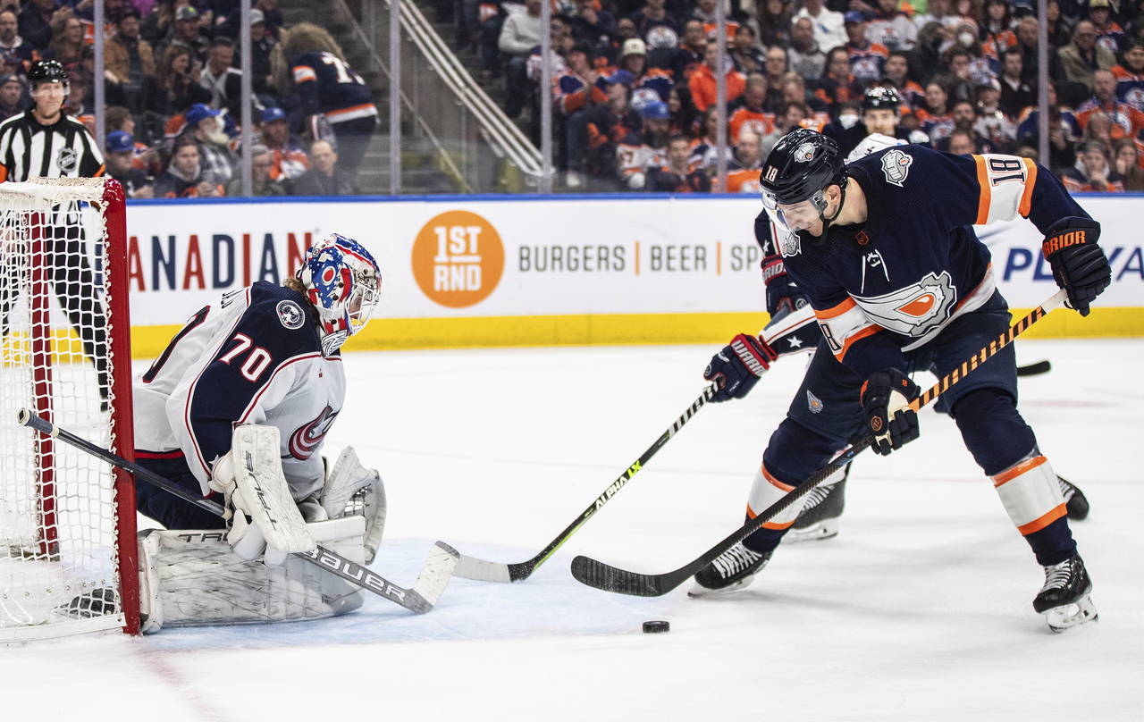 Columbus Blue Jackets goalie Joonas Korpisalo (70) makes a save on Edmonton Oilers' Zach Hyman (18)...