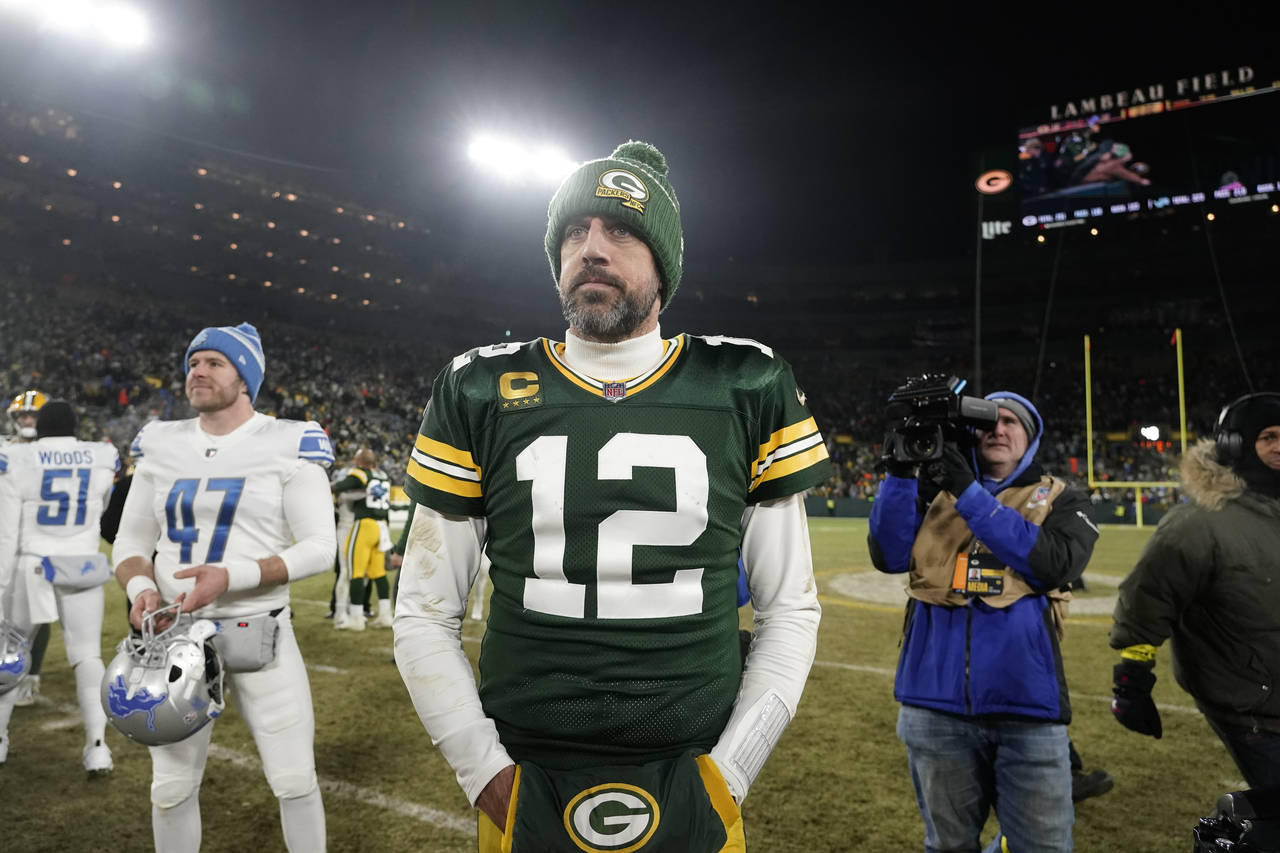 Green Bay Packers quarterback Aaron Rodgers stands on the field following an NFL football game agai...