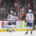 Oilers beat reeling Canucks 4-2 for 6th straight victory.