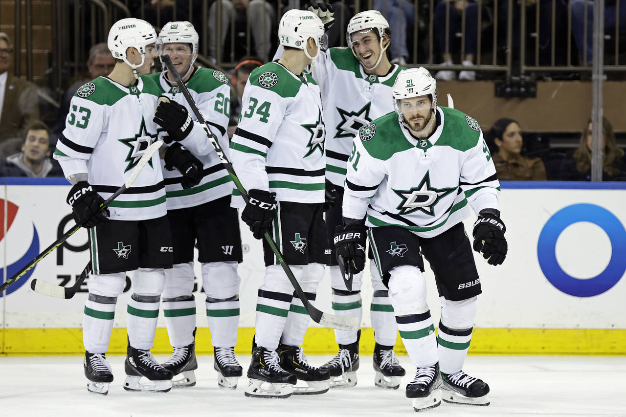 Dallas Stars center Tyler Seguin (91) skates back to the bench as teammates celebrate his goal duri...