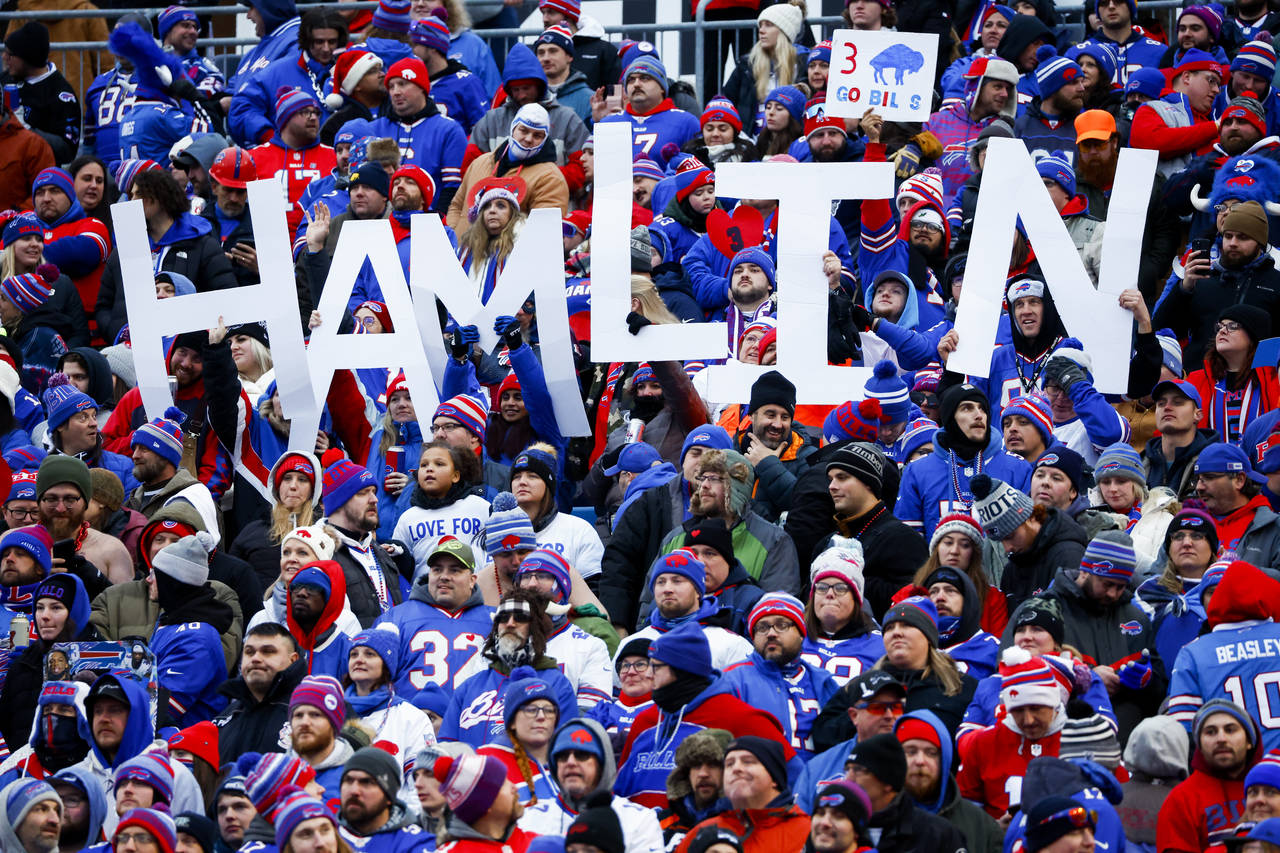 Fans hold a sign in support of Buffalo Bills safety Damar Hamlin during the second half of an NFL f...