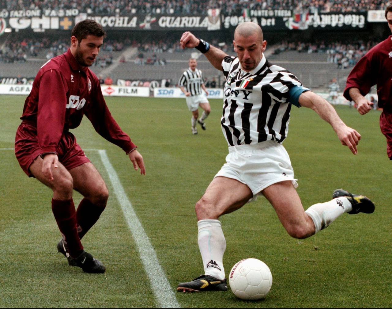 FILE - Former Italian national soccer team striker Gianluca Vialli, right, kicks the ball under the...
