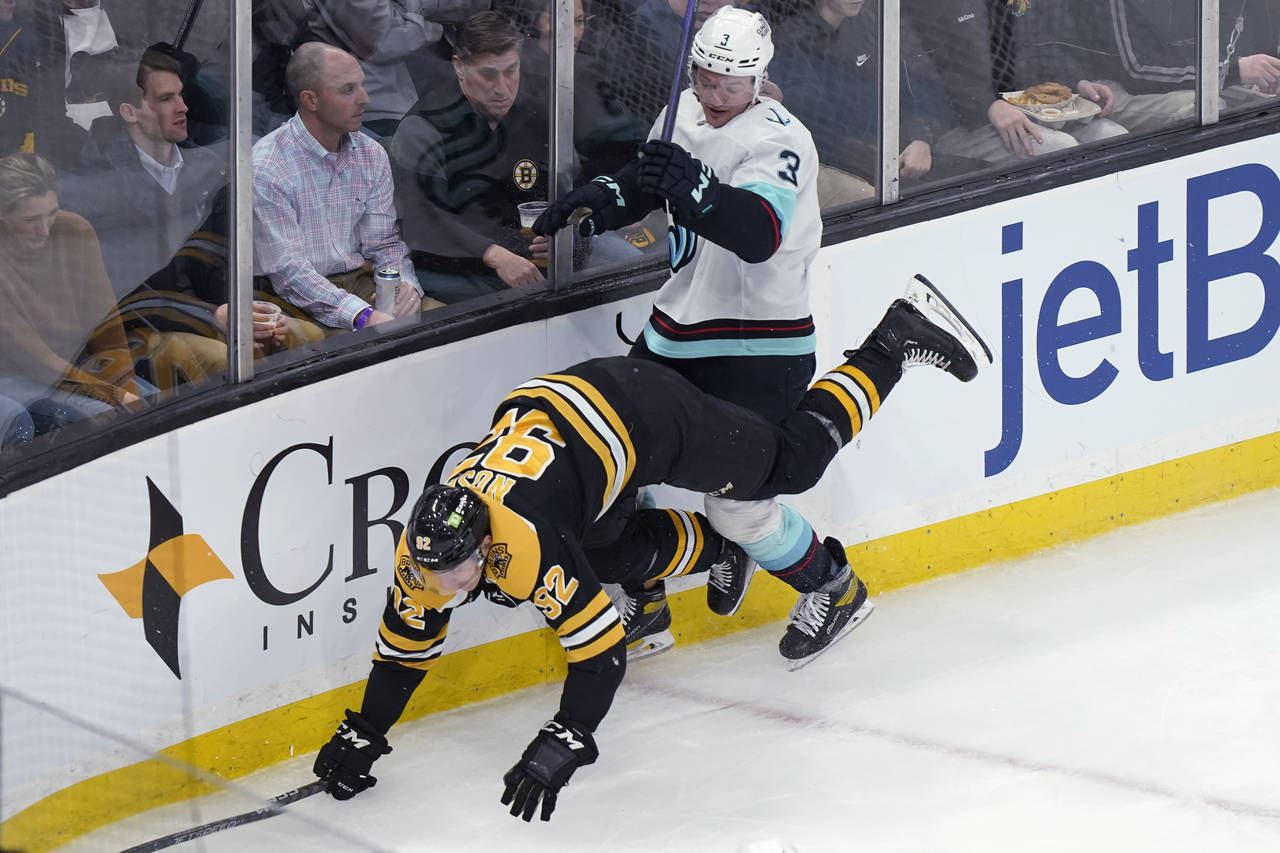 Boston Bruins left wing Tomas Nosek (92) falls after a collision with Seattle Kraken defenseman Wil...
