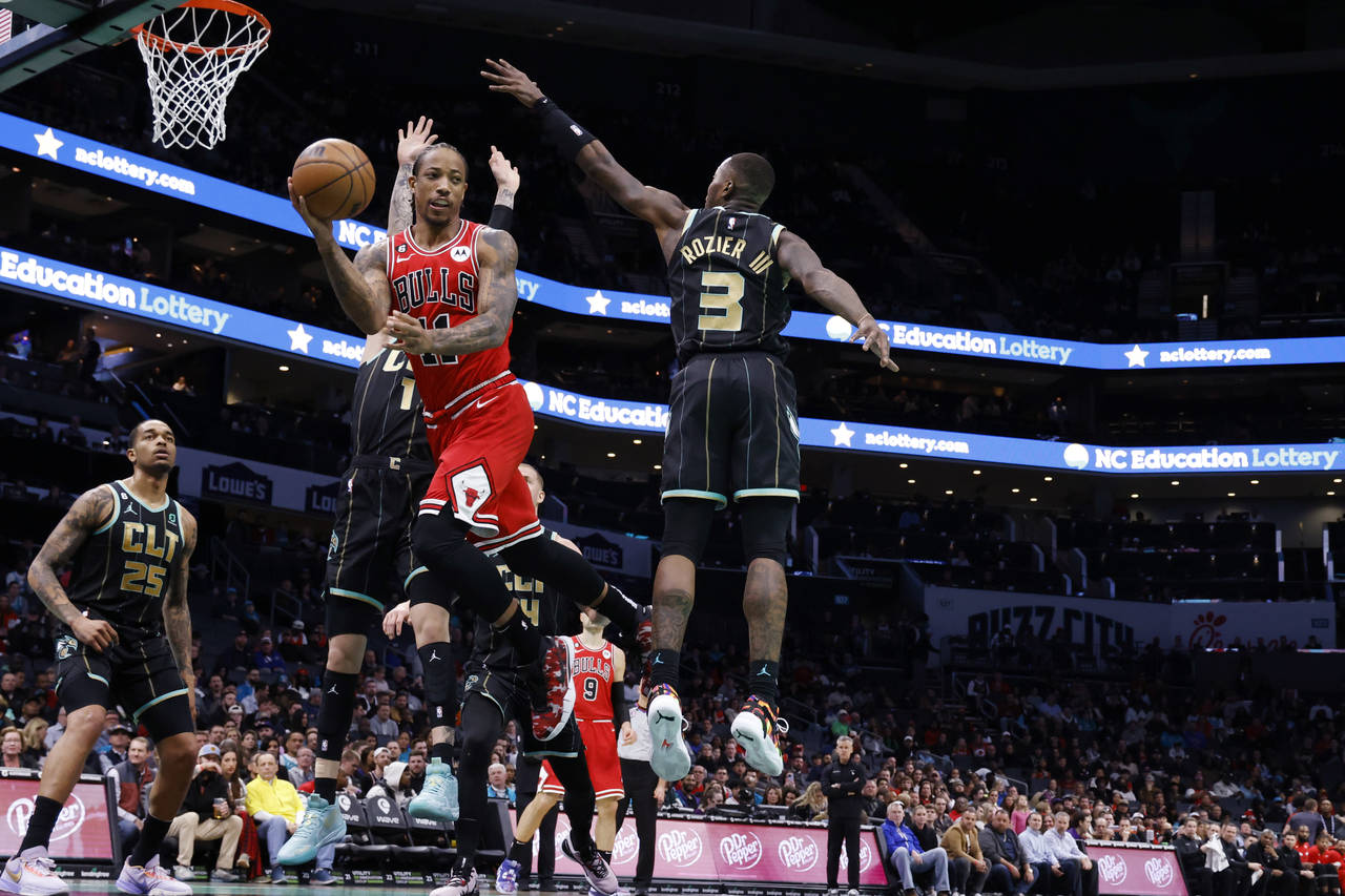 Chicago Bulls forward DeMar DeRozan (11) passes the ball around Charlotte Hornets guard Terry Rozie...