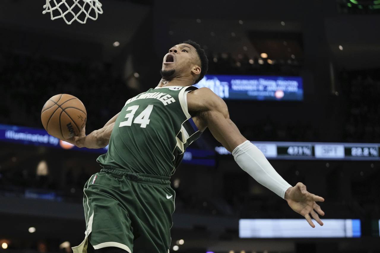 Milwaukee Bucks' Giannis Antetokounmpo dunks during the first half of an NBA basketball game Tuesda...