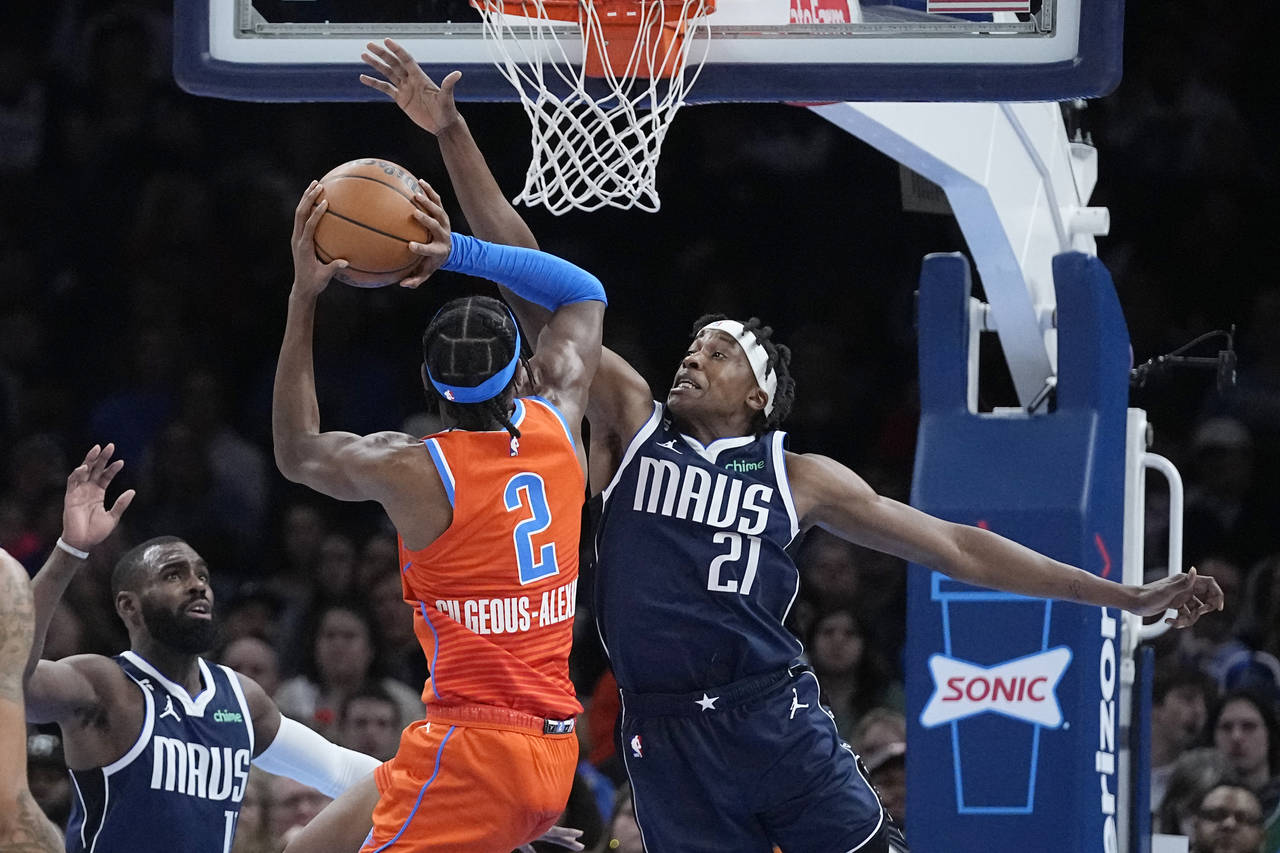 Oklahoma City Thunder guard Shai Gilgeous-Alexander (2) is fouled by Dallas Mavericks guard Frank N...