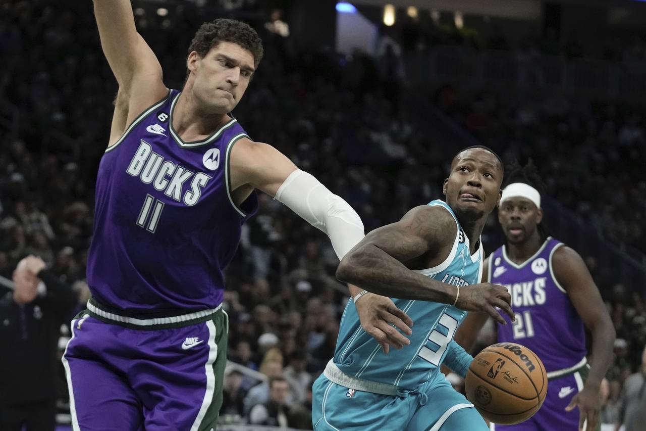 Charlotte Hornets' Terry Rozier drives past Milwaukee Bucks' Brook Lopez during the first half of a...