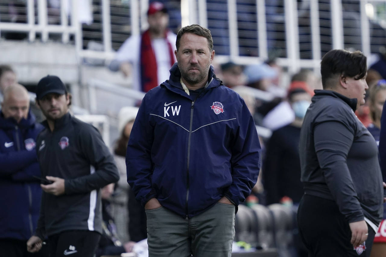 FILE - Washington Spirit head coach Kris Ward, center, stands pitch side during the second half of ...
