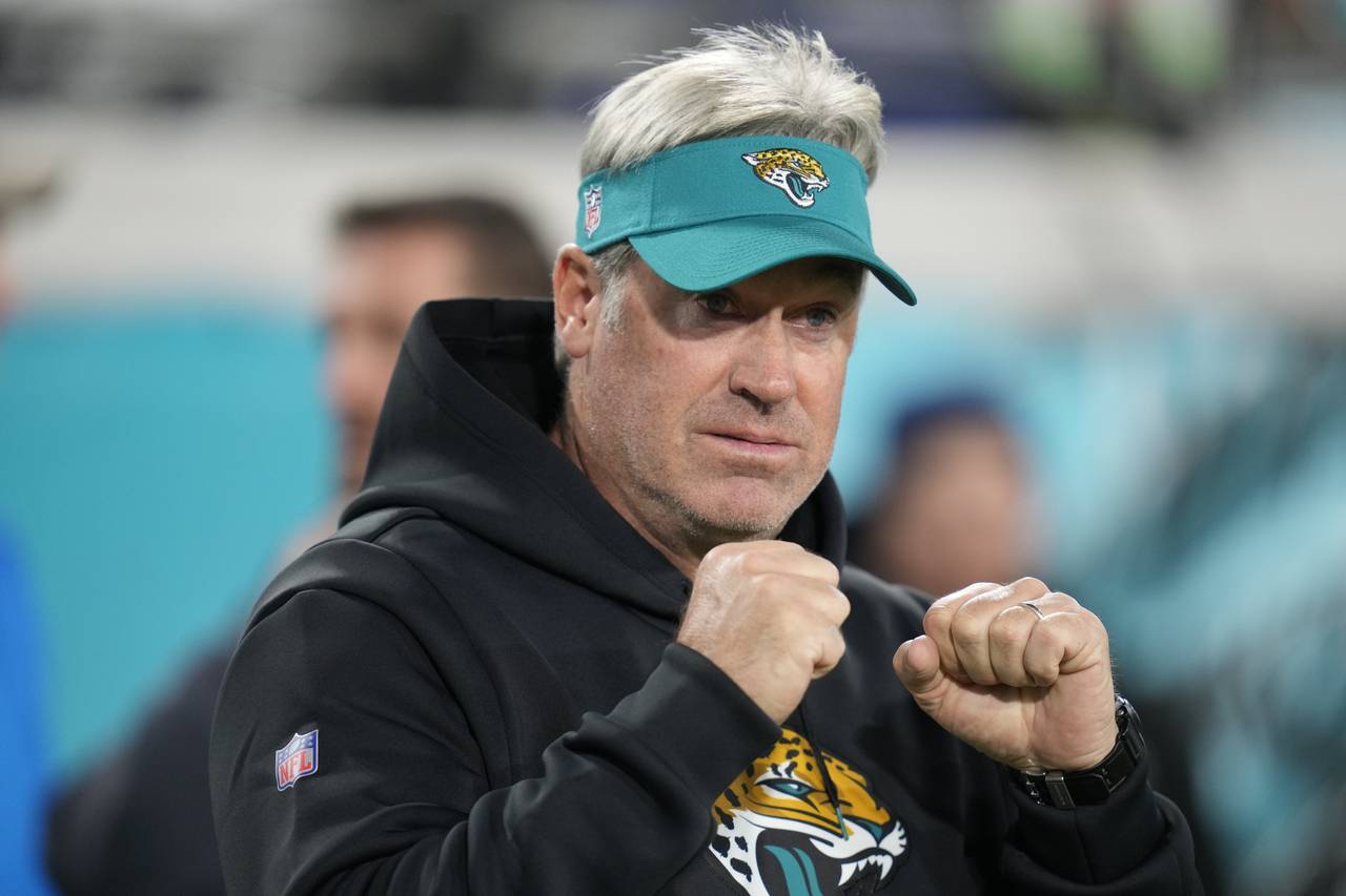 Jacksonville Jaguars head coach Doug Pederson walks the turf before an NFL wild-card football game ...