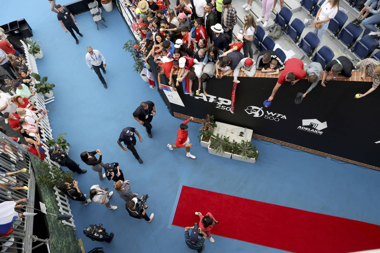 Serbia's Novak Djokovic signs autographs after defeating France's Quentin Halys during their Round ...