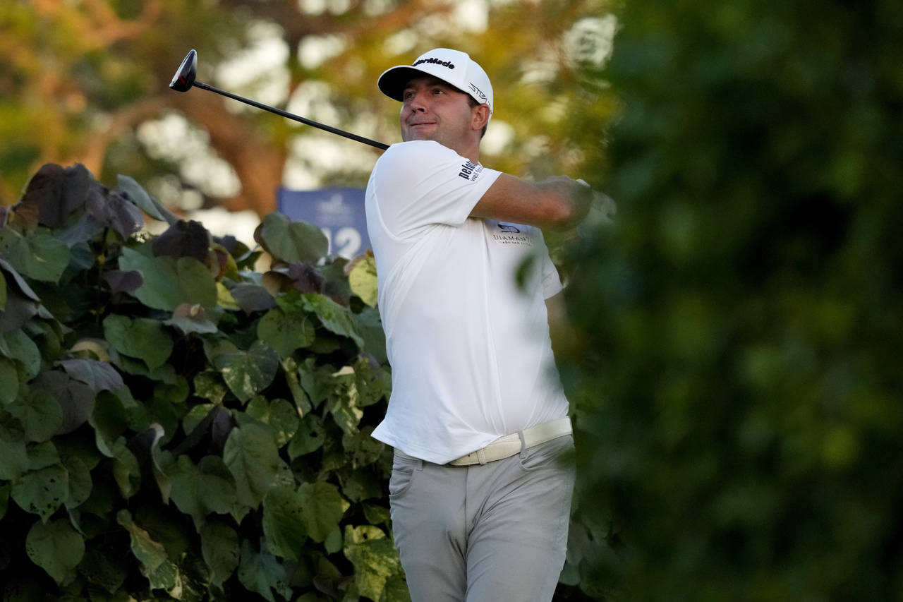 Taylor Montgomery plays his shot from the 18th tee during the first round of the Sony Open golf tou...