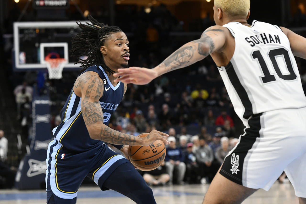 Memphis Grizzlies guard Ja Morant drives against San Antonio Spurs forward Jeremy Sochan (10) durin...