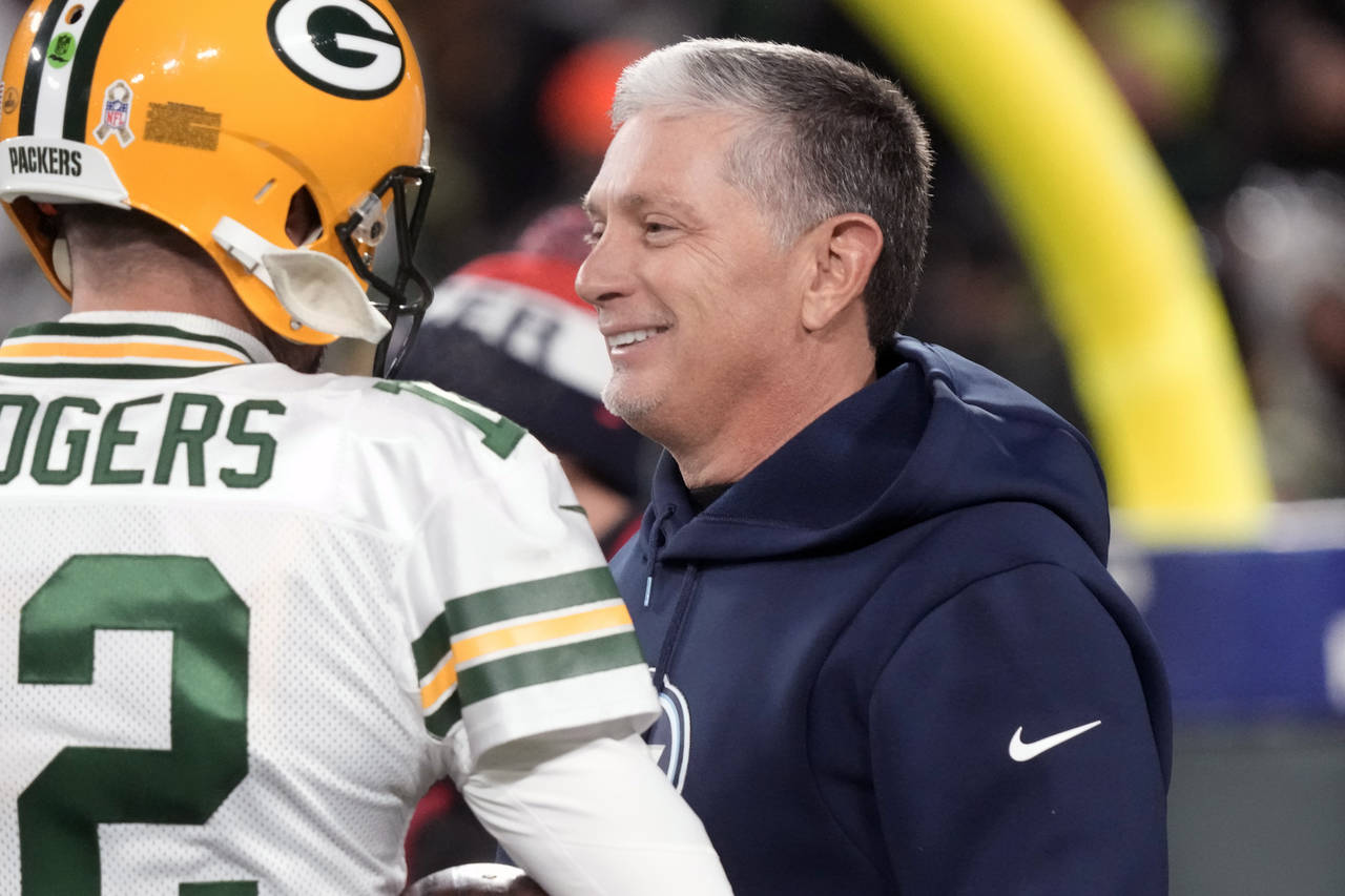 FILE - Green Bay Packers quarterback Aaron Rodgers talks with Tennessee Titans senior advisor Jim S...