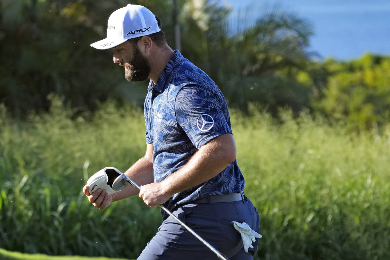 Jon Rahm, of Spain, walks off the 14th green during the first round of the Tournament of Champions ...