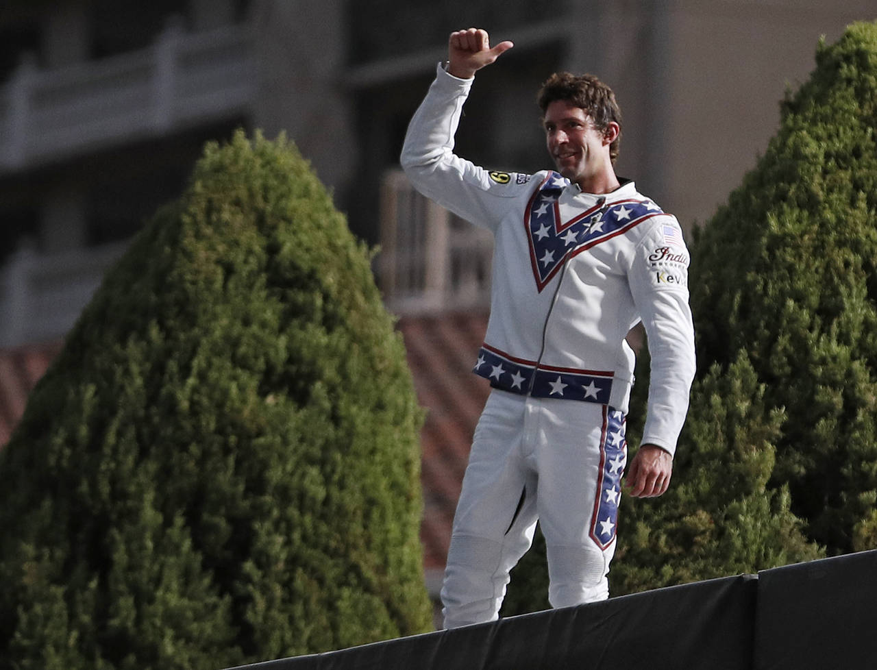 FILE - Travis Pastrana celebrates after jumping the fountain at Caesars Palace on a motorcycle Sund...
