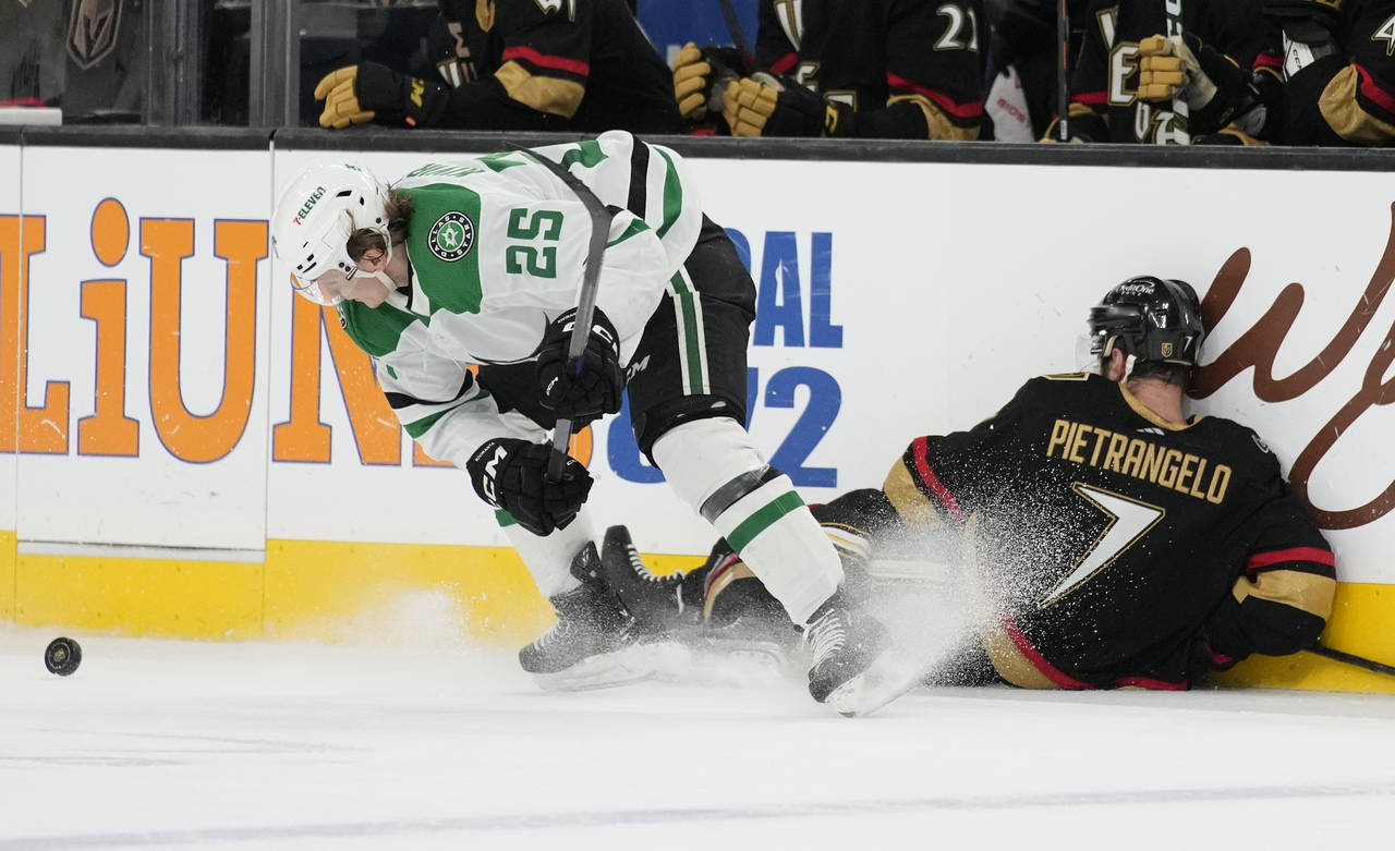 Vegas Golden Knights defenseman Alex Pietrangelo (7) falls into the boards beside Dallas Stars left...