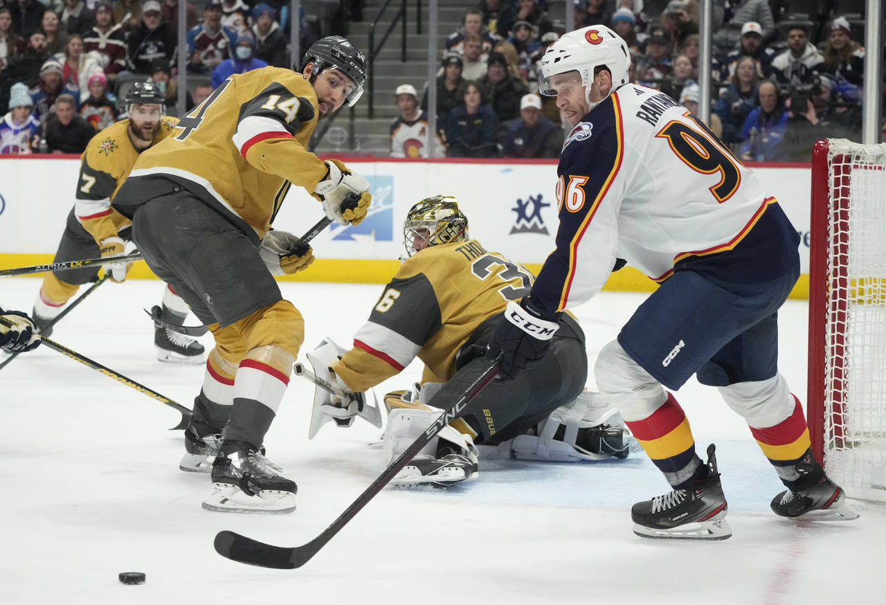 Colorado Avalanche right wing Mikko Rantanen, right, reaches out for the puck after Vegas Golden Kn...