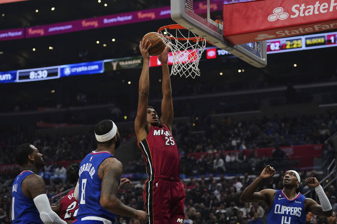 Miami Heat center Orlando Robinson (25) slam-dunks during the first half of an NBA basketball game ...