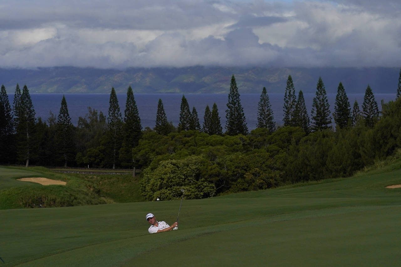 Justin Thomas plays a shot from a bunker on the ninth hole during the Tournament of Champions pro-a...