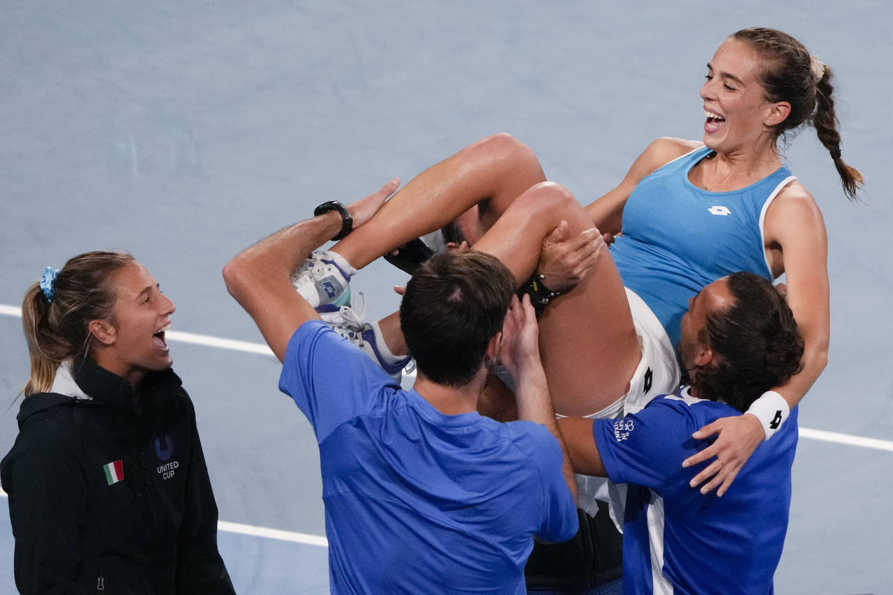 Italy's Lucia Bronzetti, centre, is held aloft by teammates after defeating Valentini Grammatikopou...