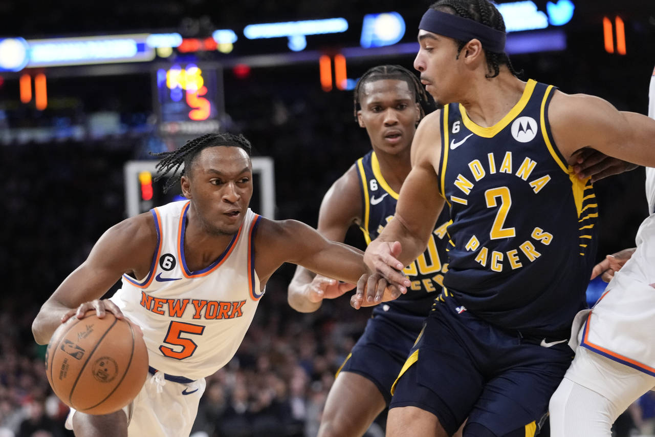 New York Knicks guard Immanuel Quickley (5) drives to the basket against Indiana Pacers guard Andre...