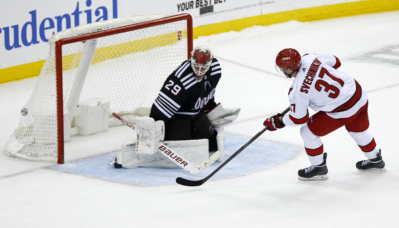 Carolina Hurricanes forward Andrei Svechnikov (37) scores a shootout goal against New Jersey Devils...