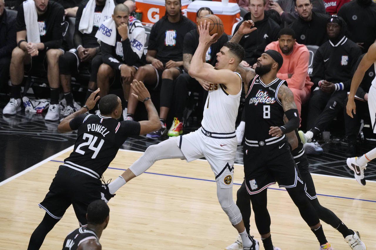 Denver Nuggets forward Michael Porter Jr., center, drives to the basket past Los Angeles Clippers f...