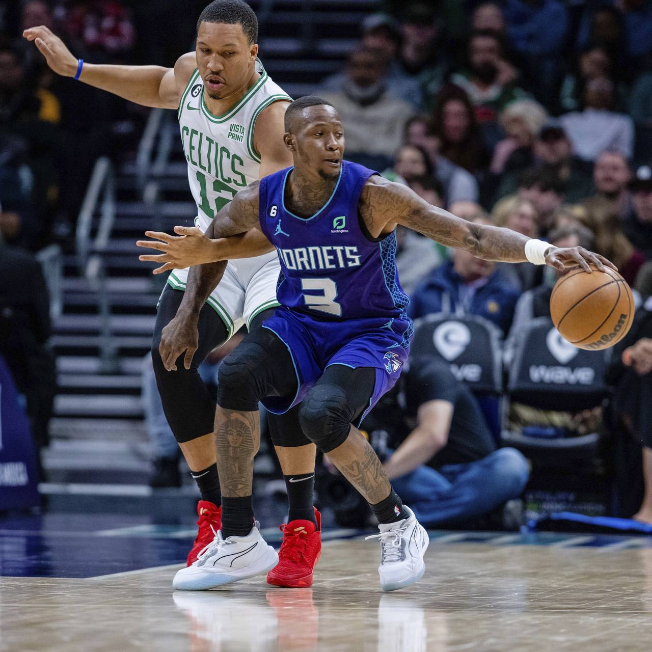 Charlotte Hornets guard Terry Rozier (3) spins around Boston Celtics forward Grant Williams (12) as...