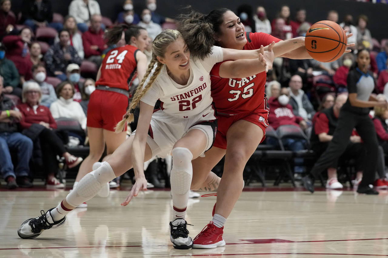 Stanford forward Cameron Brink, left, and Utah forward Alissa Pili compete for possession of the ba...