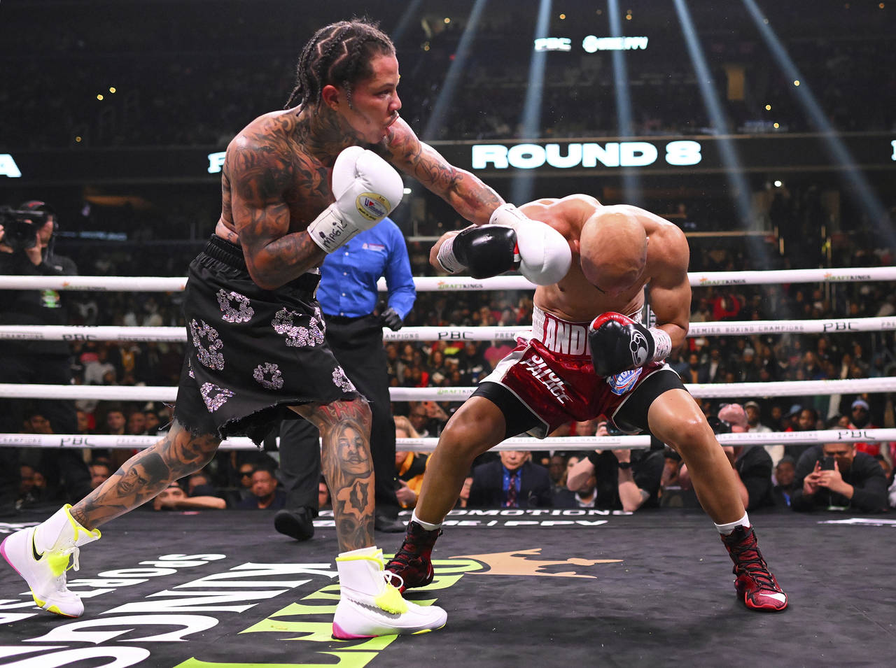 Gervonta Davis, left, delivers a shot to the head of Luis Garcia in the 8th round of their boxing m...