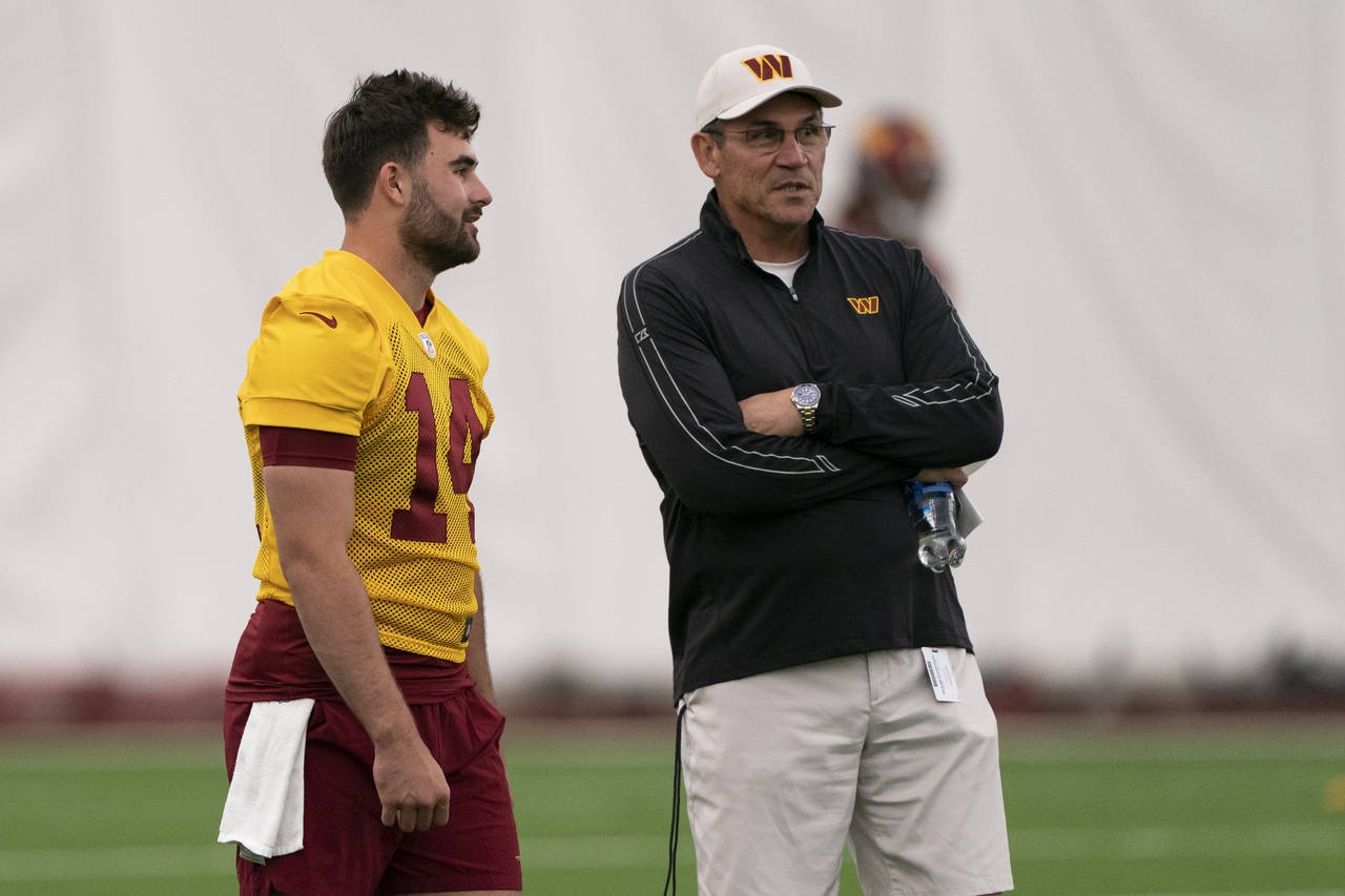 FILE - Washington Commanders quarterback Sam Howell, left, talks with coach Ron Rivera during the N...