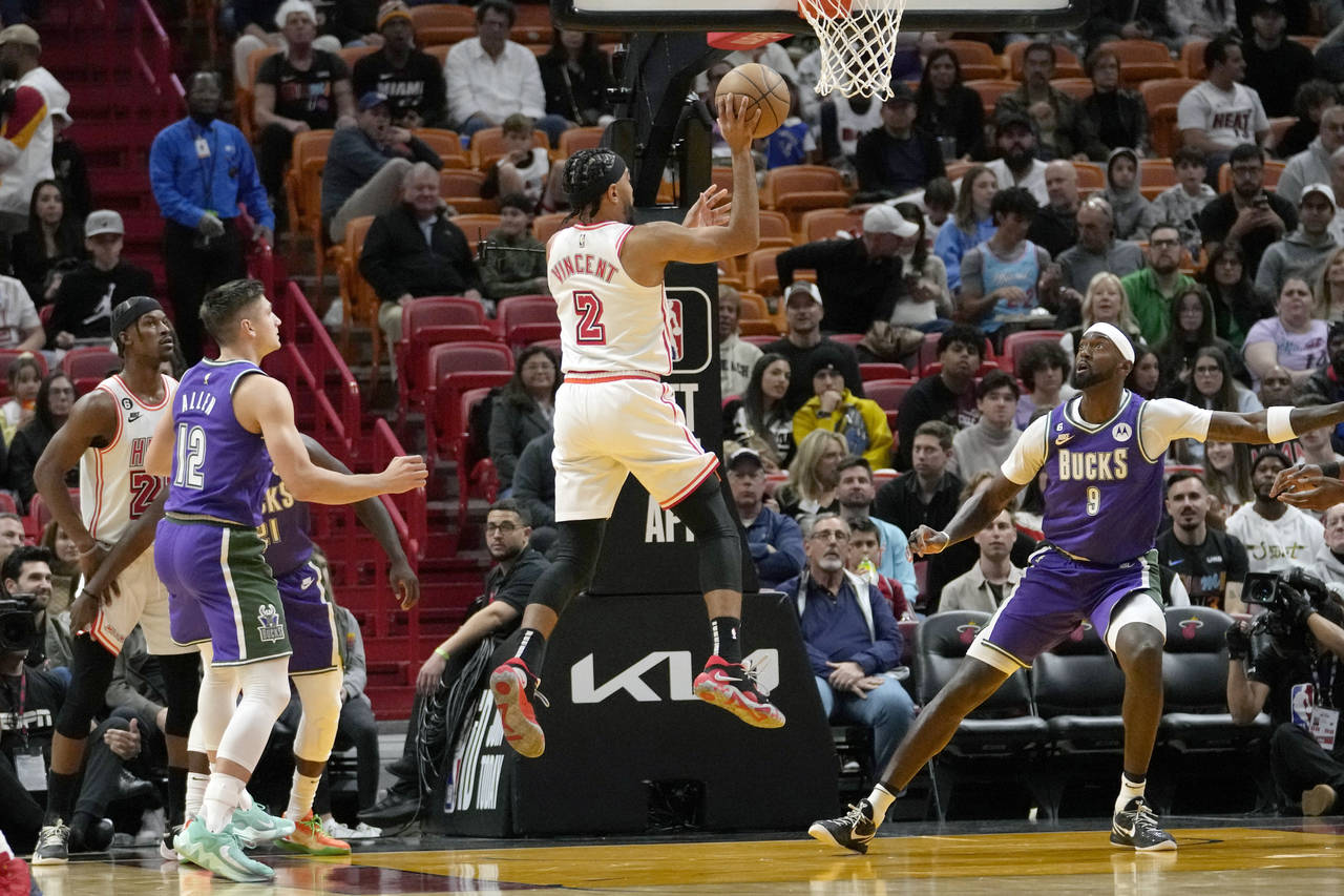 Miami Heat guard Gabe Vincent (2) goes to the basket as Milwaukee Bucks guard Grayson Allen (12) an...