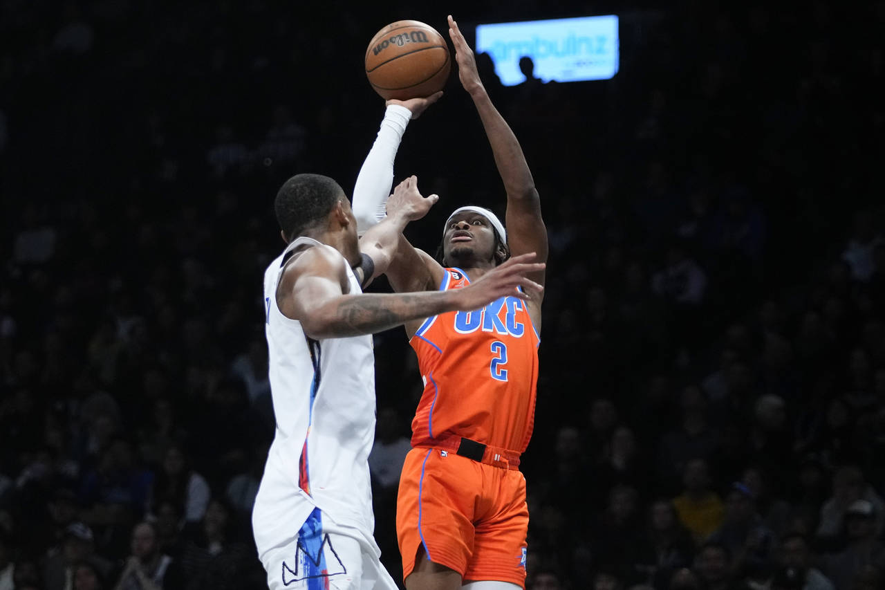 Oklahoma City Thunder's Shai Gilgeous-Alexander (2) shoots over Brooklyn Nets' Nic Claxton during t...