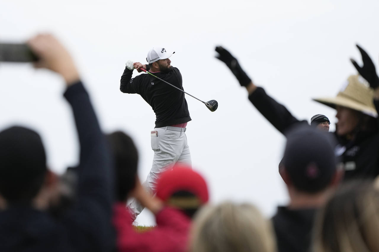 Jon Rahm, of Spain, watches his tee shot on the fourth hole of the South Course at Torrey Pines dur...