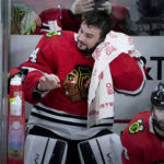 
              Chicago Blackhawks goaltender Petr Mrazek wipes his head after being replaced during the first period of the team's NHL hockey game against the Seattle Kraken on Saturday, Jan. 14, 2023, in Chicago. (AP Photo/Charles Rex Arbogast)
            
