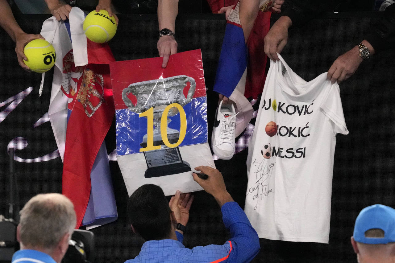 Novak Djokovic of Serbia signs autographs after defeating Andrey Rublev of Russia in their quarterf...