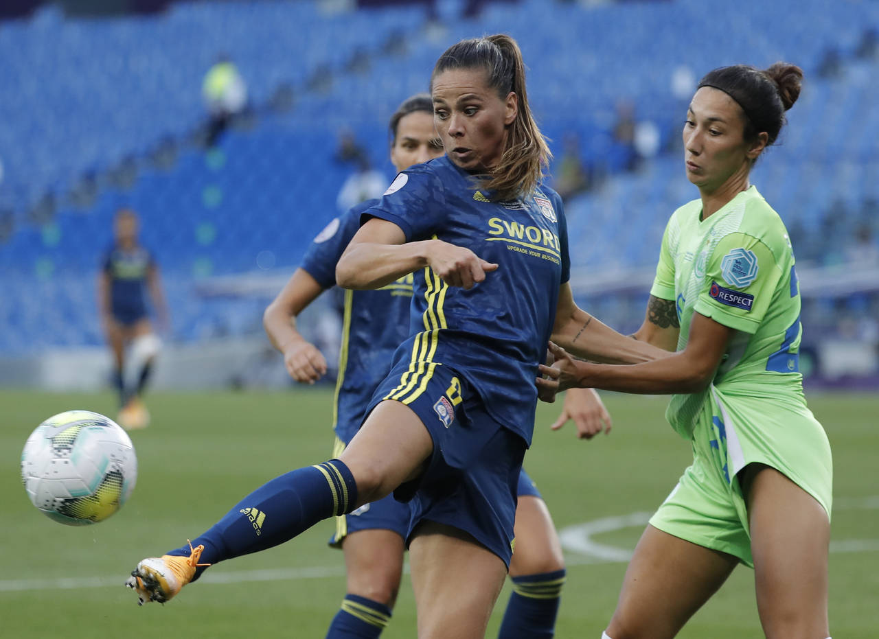 FILE - Lyon's Sara Bjork Gunnarsdottir, left, duels for the ball with Wolfsburg's Sara Doorsoun-Kha...
