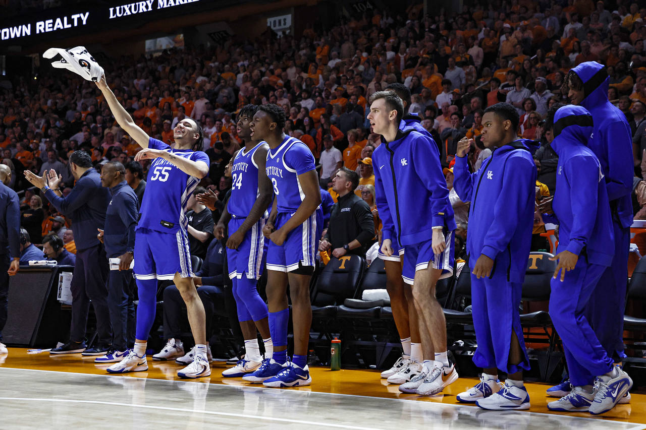 Kentucky players celebrate on the bench during the second half of an NCAA college basketball game a...