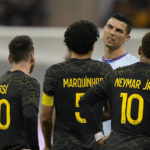 Bruised Ronaldo scores twice to edge showdown with Messi