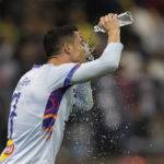 Bruised Ronaldo scores twice to edge showdown with Messi