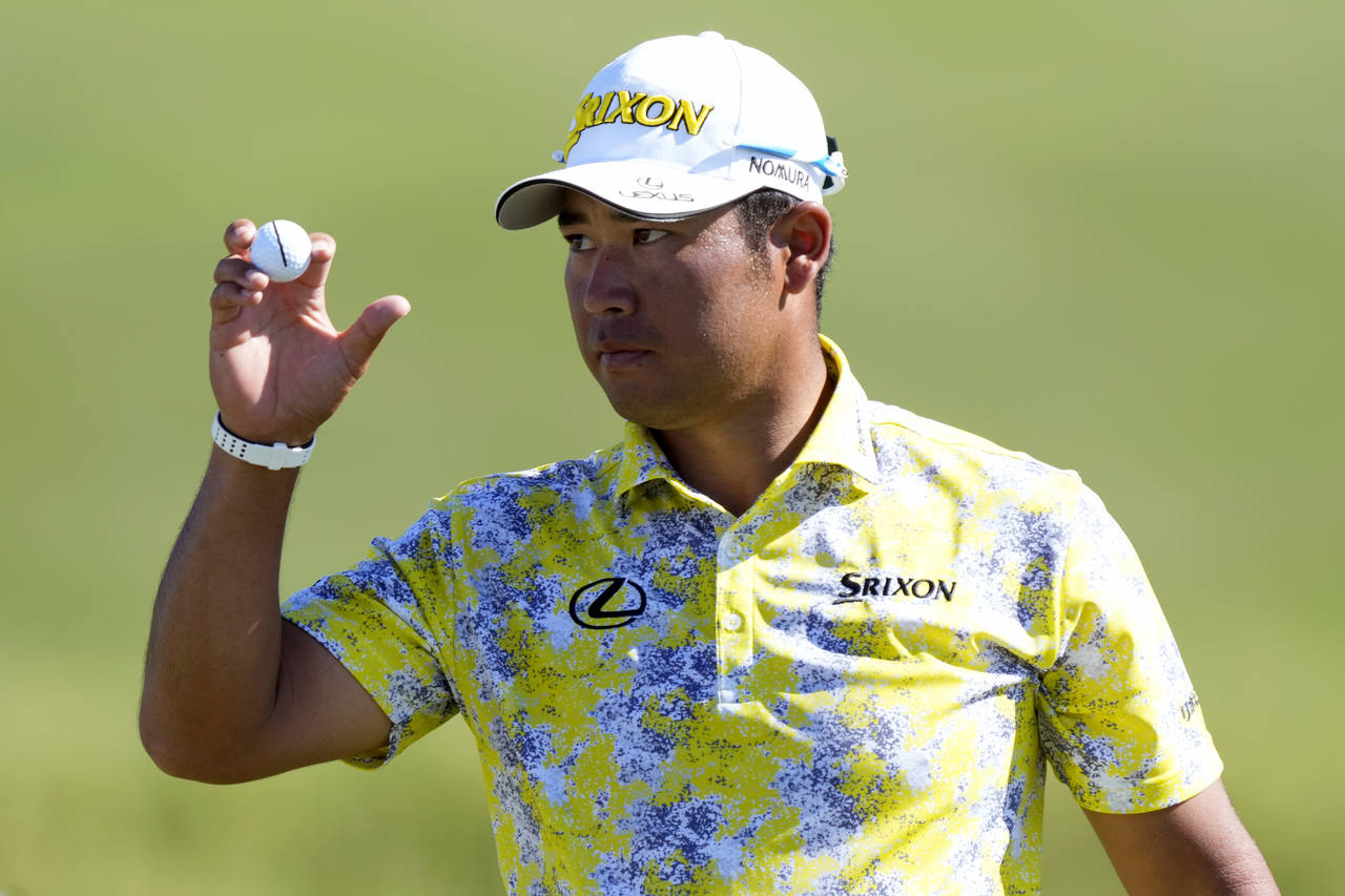 Hideki Matsuyama, of Japan, acknowledges the gallery from the 18th green during the final round of ...