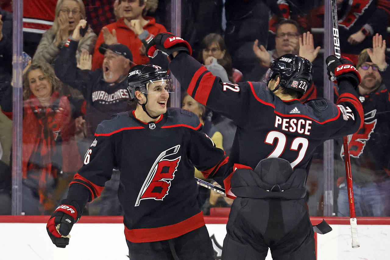 Carolina Hurricanes' Brady Skjei (76) celebrates his goal with Brett Pesce (22) during the first pe...