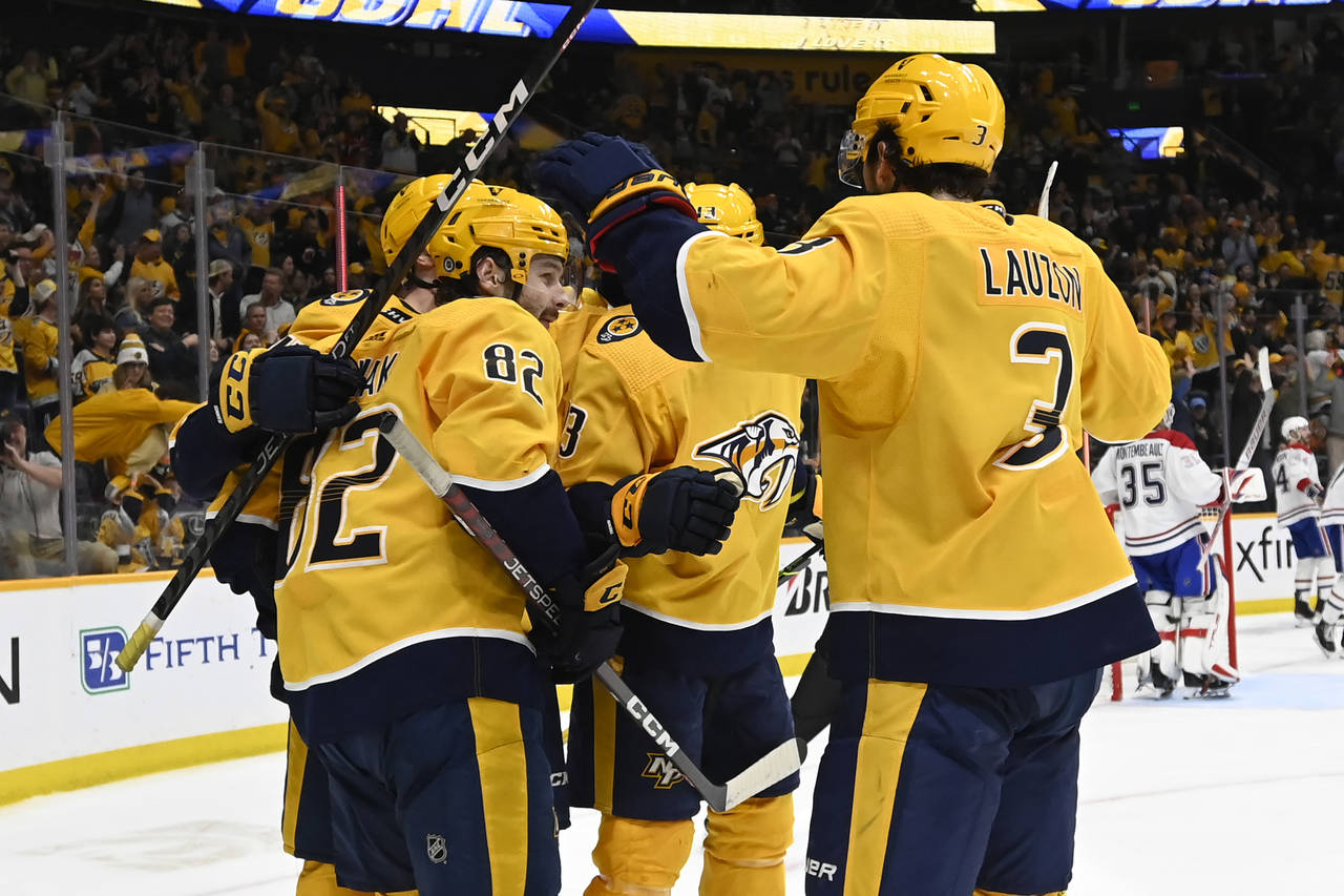Nashville Predators center Thomas Novak (82) celebrates with teammates after scoring a goal against...