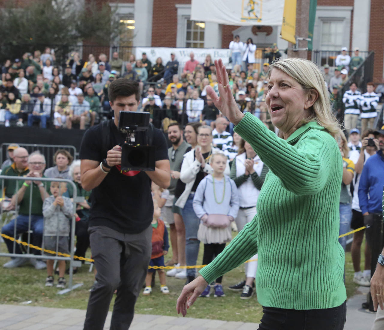 Baylor University President Linda Livingstone waves to a crowd during their annual homecoming parad...