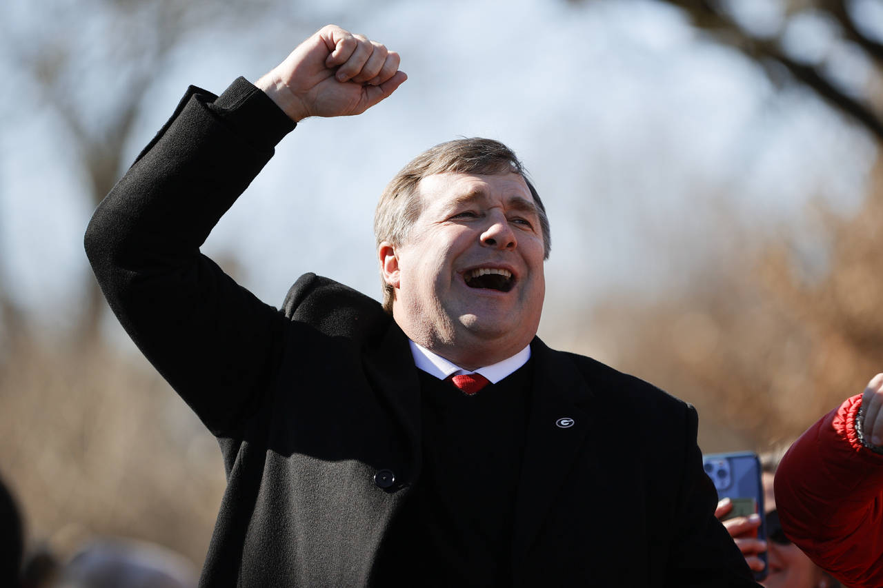Georgia head coach Kirby Smart cheers with the crowd during a parade celebrating the Bulldog's seco...