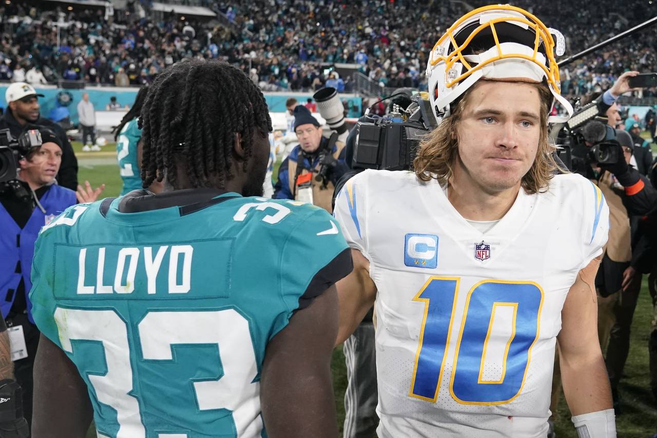 Los Angeles Chargers quarterback Justin Herbert (10) walks off the field after an NFL wild-card foo...