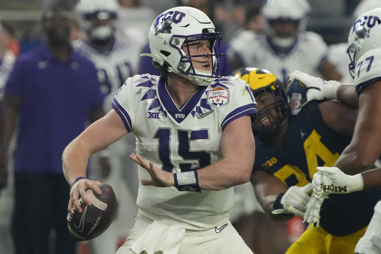TCU quarterback Max Duggan (15) looks to pass against Michigan during the first half of the Fiesta ...