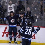 Connor's hat trick powers Jets' 7-4 win over Canucks